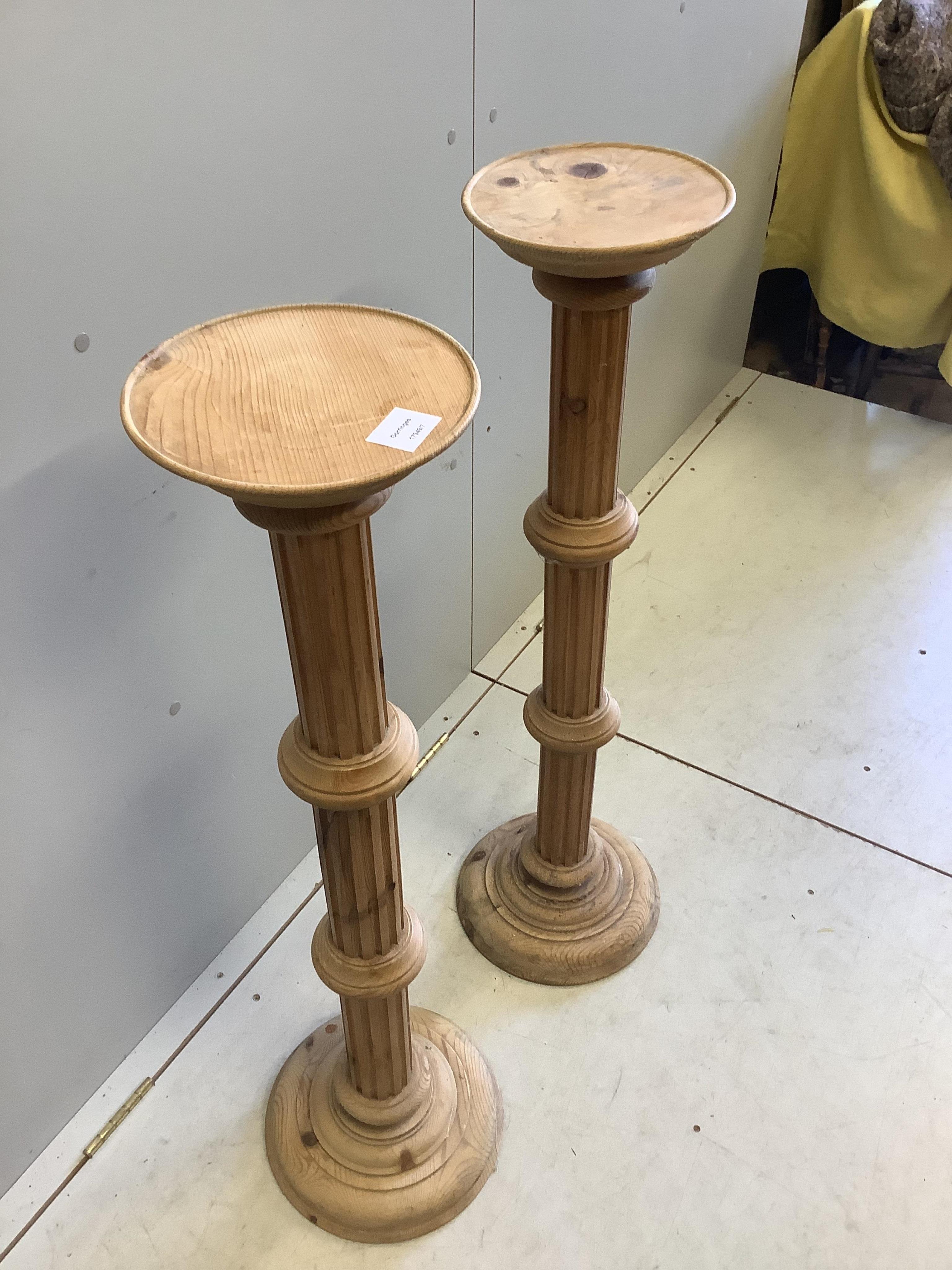 A pair of 19th century style stripped pine torcheres, height 100cm. Condition - fair